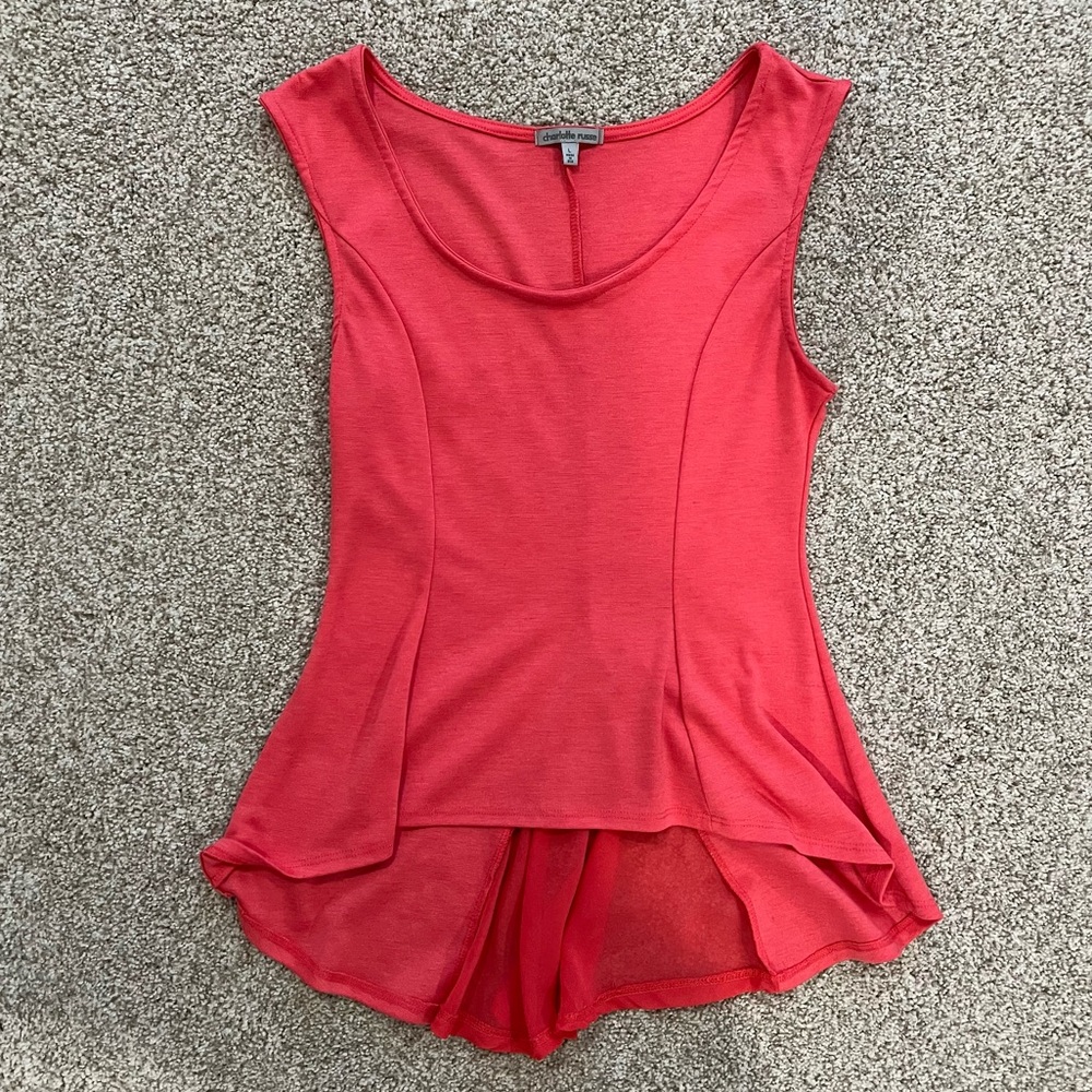 Pink peplum tank top with long back.
